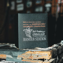 Load image into Gallery viewer, Black card with text and branding on a rustic surface with blurred background