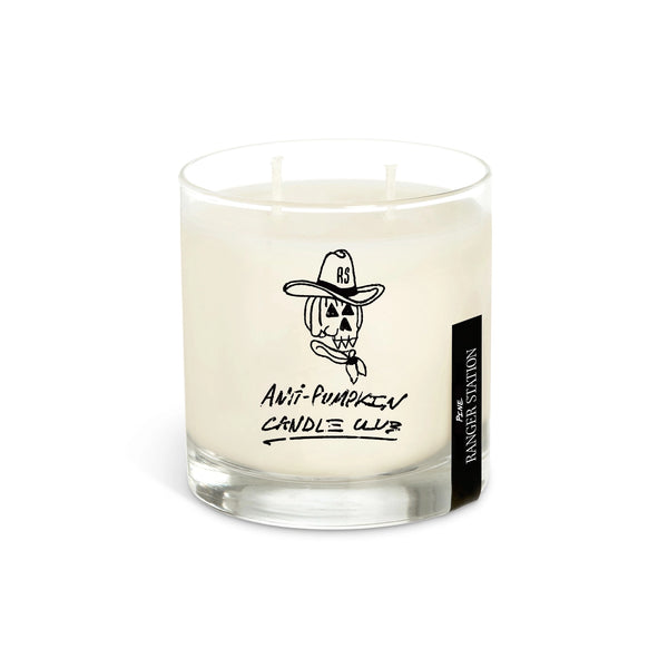 Candle with a label and a box on a dark background